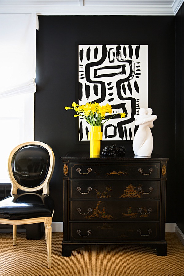 black wall and yellow vase