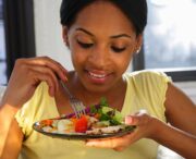 black woman eating a salad