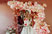 Bride & Groom holding cake in Valentine's Themed wedding shoot.