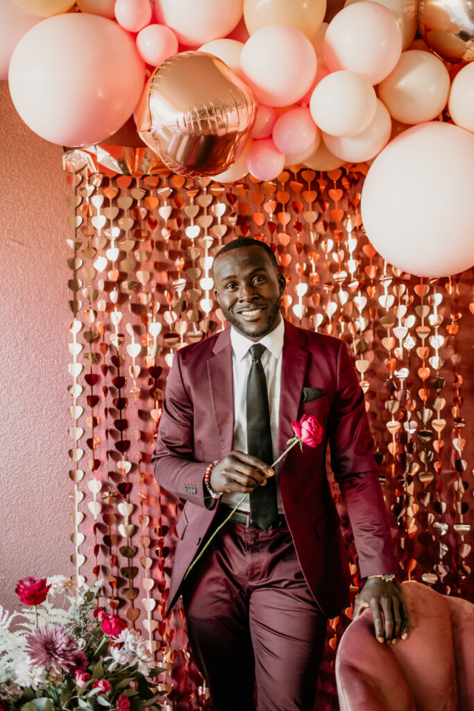 Groom wearing red tux.