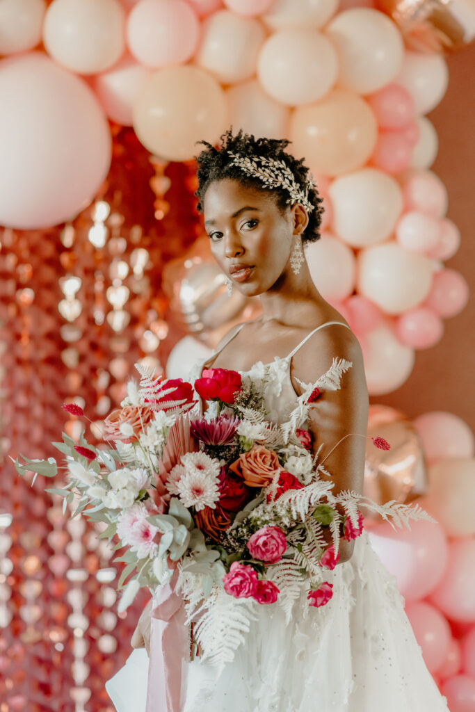 Bride with flowers in romantic Valentine's Wedding shoot.