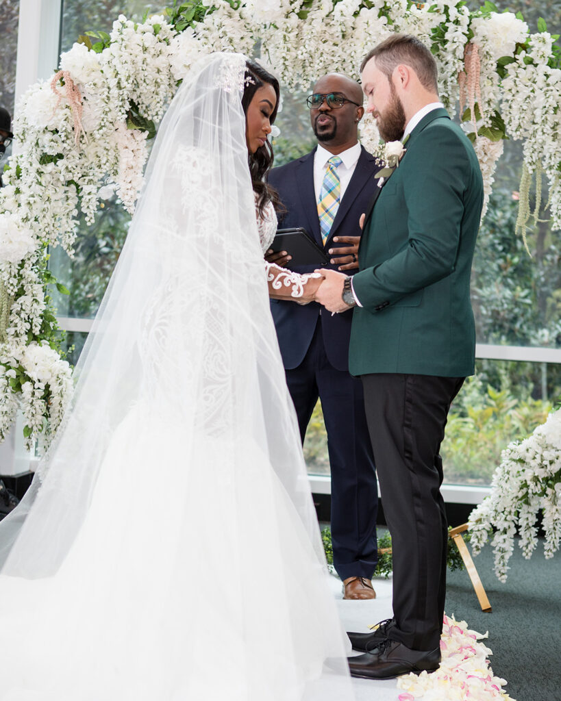 Bride and groom in moment of prayer during vows at intimate micro wedding in Virginia. 