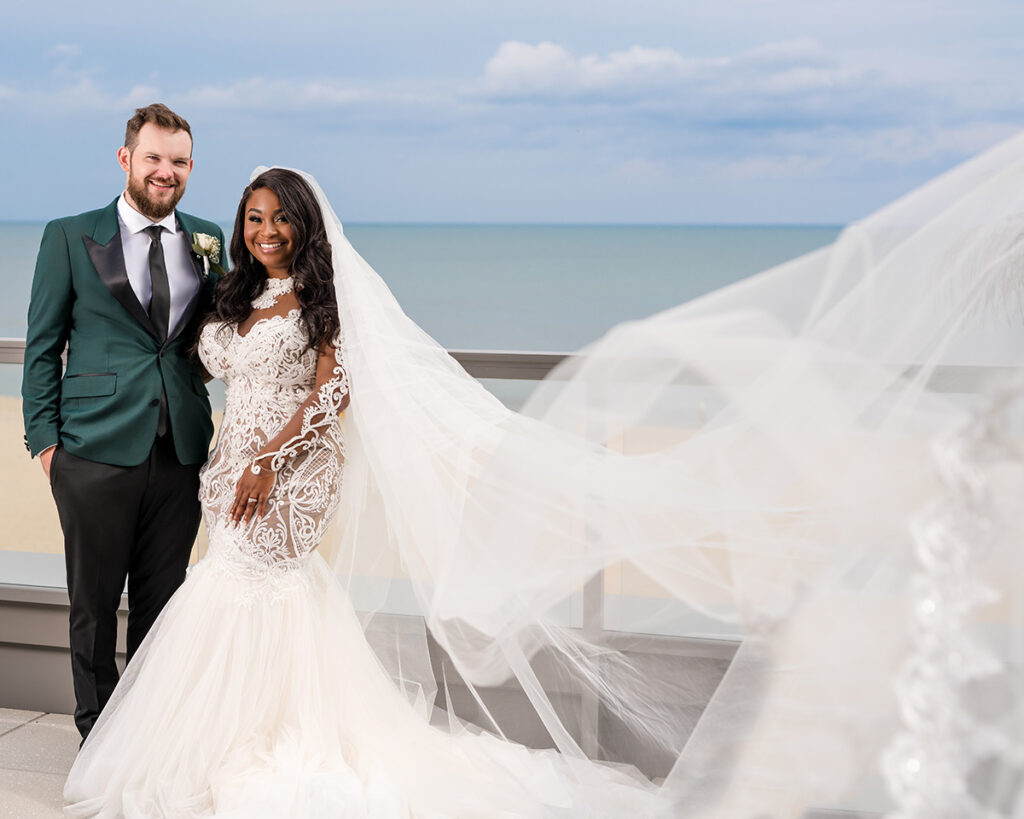 Bride and groom posing in front of the ocean at their intimate micro wedding.