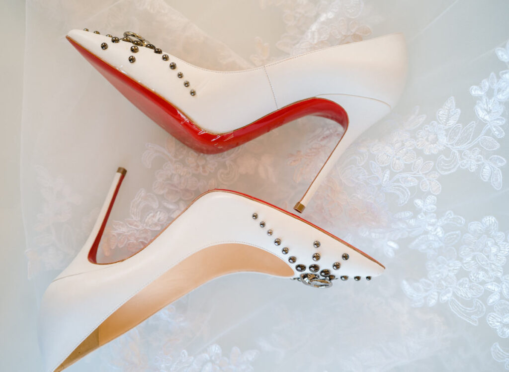 Detail shot of bride's Louis Vuitton red bottom shoes in culture fusion micro wedding.