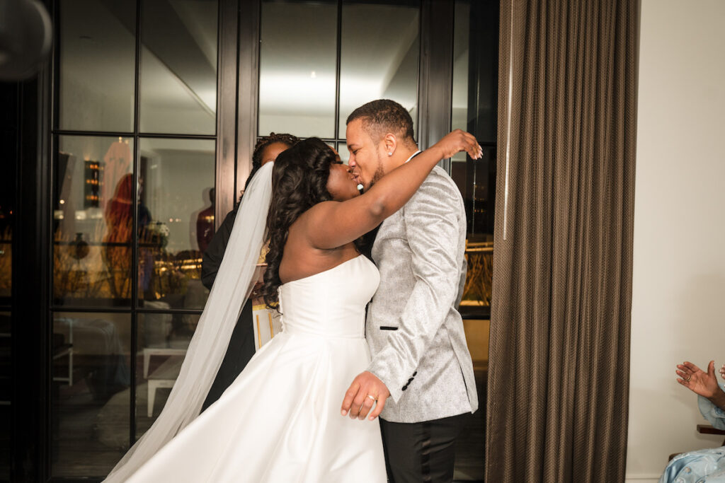 Bride and groom kissing in culture fusion micro wedding.