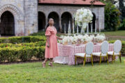 Model posing in front of blooming spring wedding styled shoot.