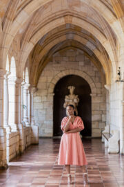 Blooming Spring wedding still shot of model under Spanish Monastery arches.