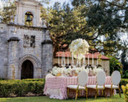 White and pastel floral arrangements for blooming spring wedding themed tablescape.