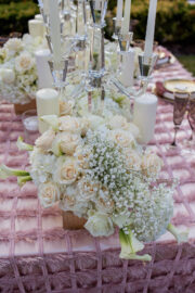 White and pastel floral arrangements for blooming spring wedding themed tablescape.