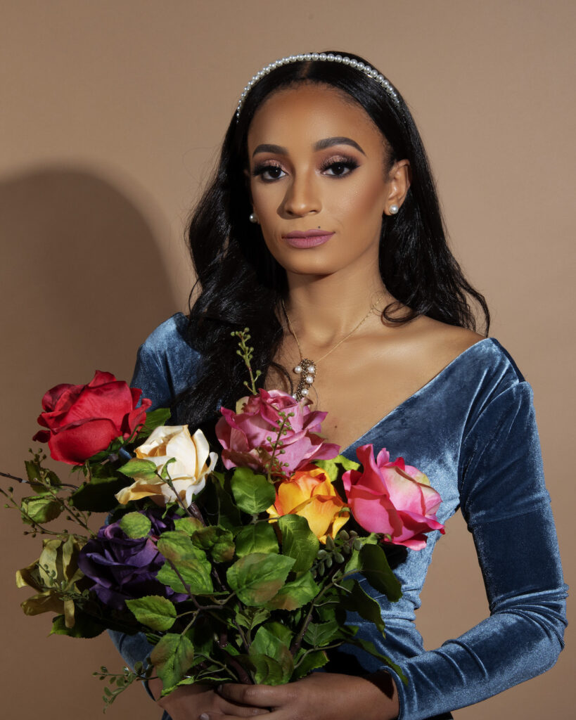 Future Bride posing with bouquet of flowers in elegant winter engagement session.