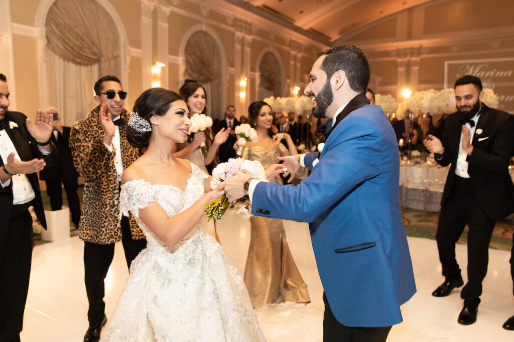 Bride and Groom dancing with guests at their classic luxurious wedding.