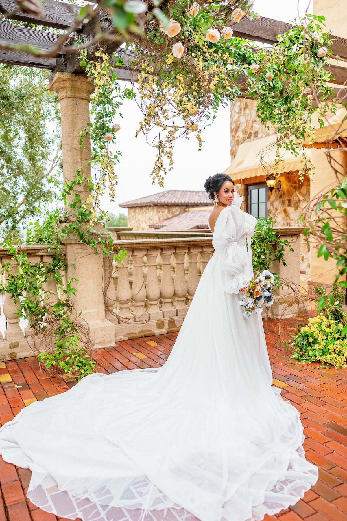 Featured in Issue No. 27, the Bella Collina venue in Central Florida sets the scene for a Tuscany-inspired blue & yellow wedding shoot.