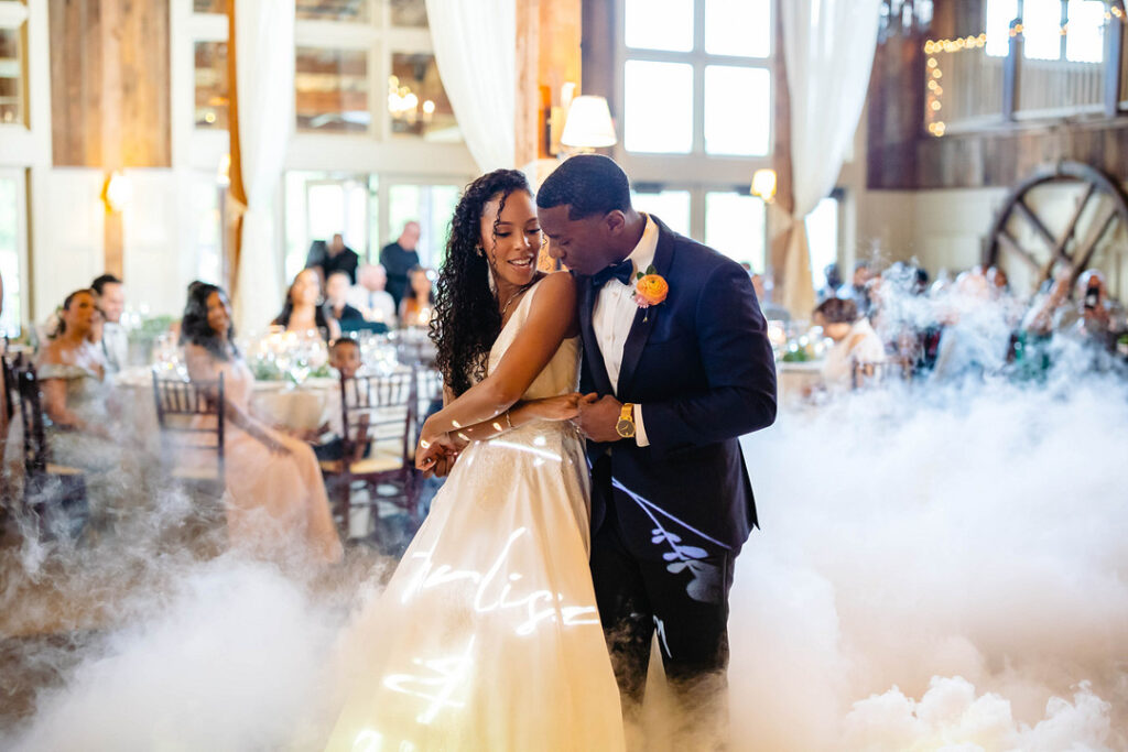 Green pastures, bright florals, a classic red barn, and two glam gowns are highlights of this chic barn wedding in Boston.