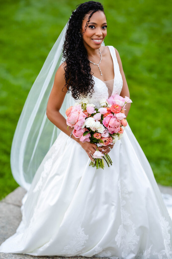 Green pastures, bright florals, a classic red barn, and two glam gowns are highlights of this chic barn wedding in Boston.