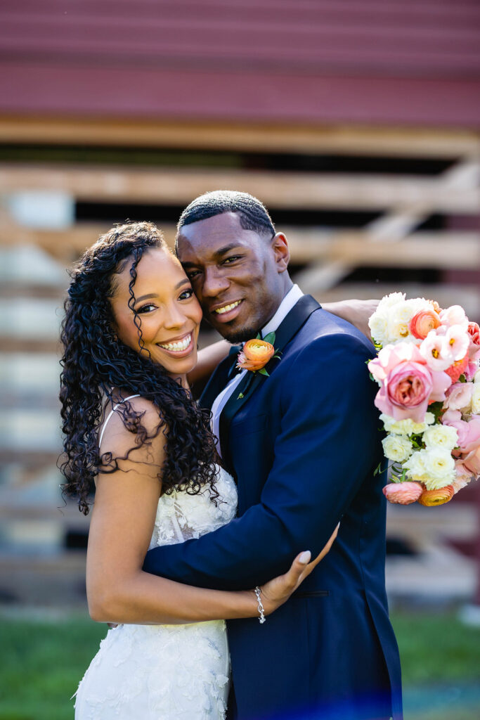 Green pastures, bright florals, a classic red barn, and two glam gowns are highlights of this chic barn wedding in Boston.