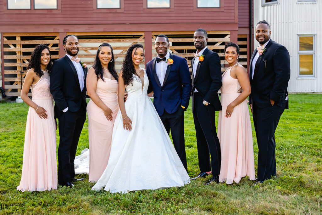 Green pastures, bright florals, a classic red barn, and two glam gowns are highlights of this chic barn wedding in Boston.