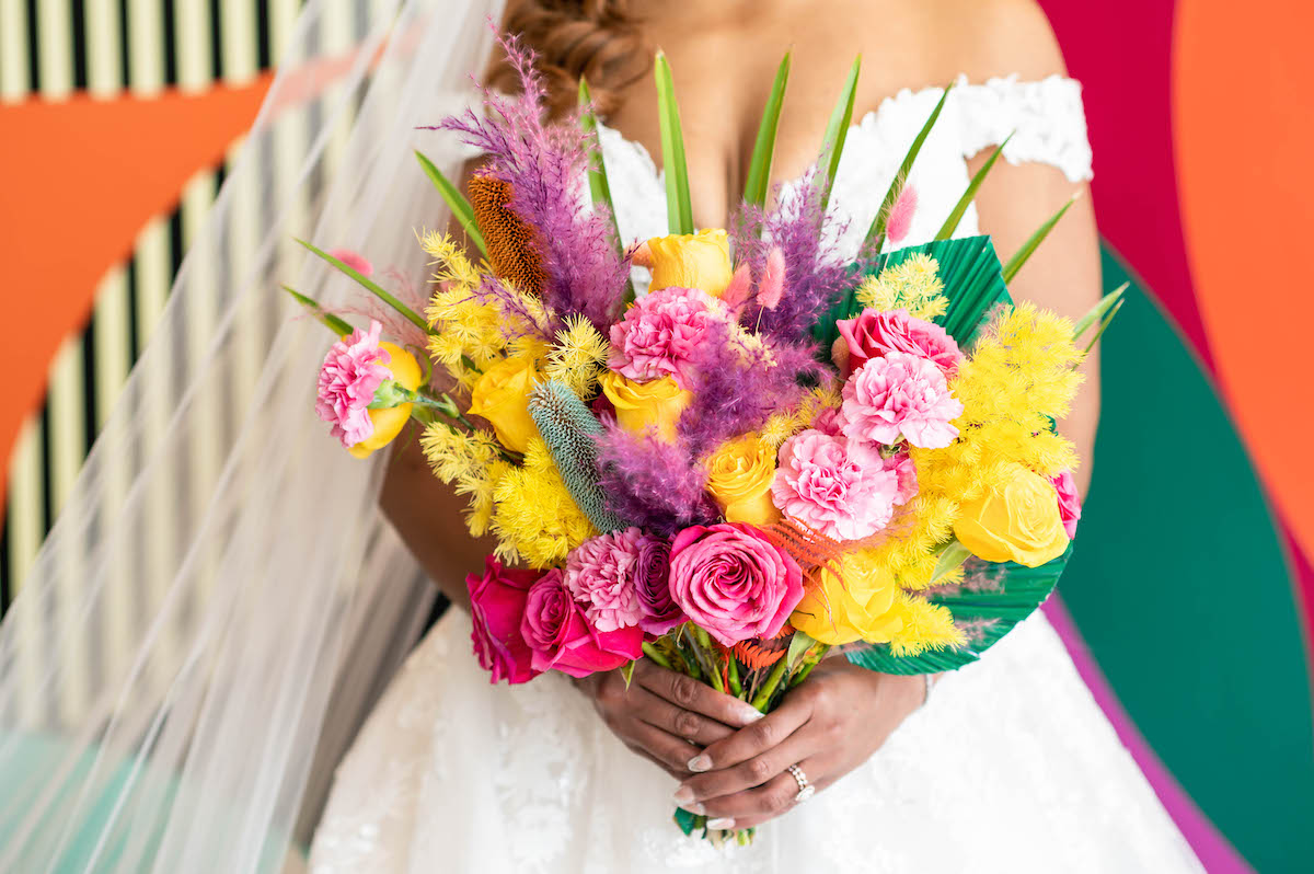 Colorful bouquet at Eclectic wedding with colorful backdrops and cool decor