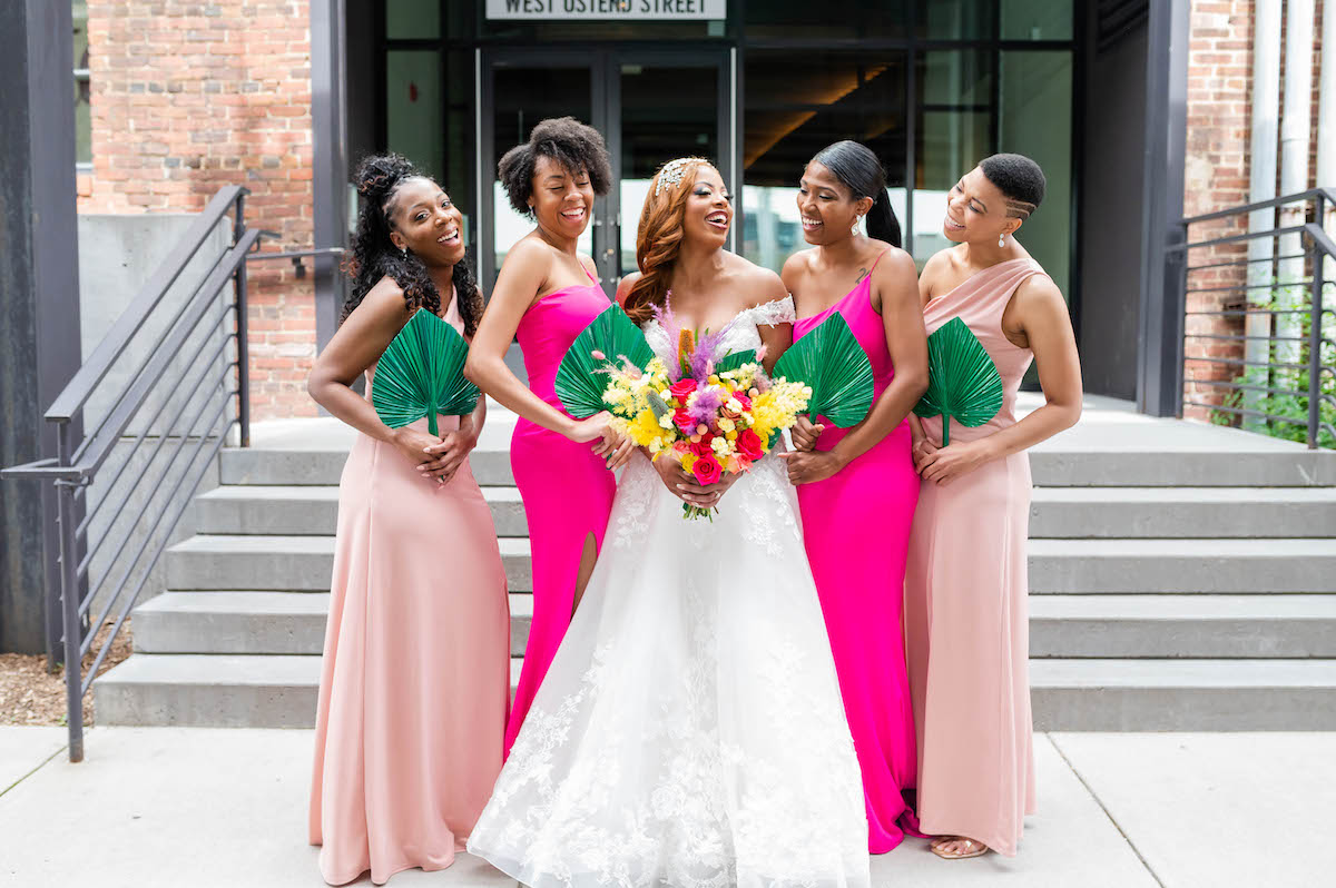 Bridesmaids with bride in Eclectic wedding with colorful backdrops and cool decor