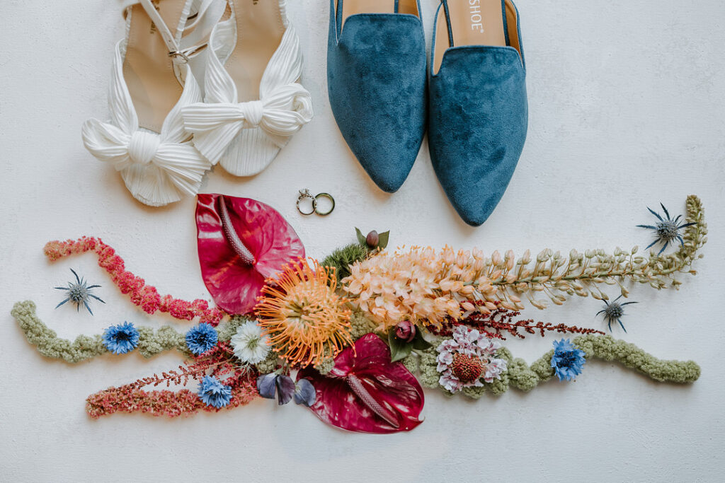 This fairytale garden-inspired styled shoot in Wisconsin highlights the LGBTQ+ community with bold jewel-tone decor and luscious floral art.  