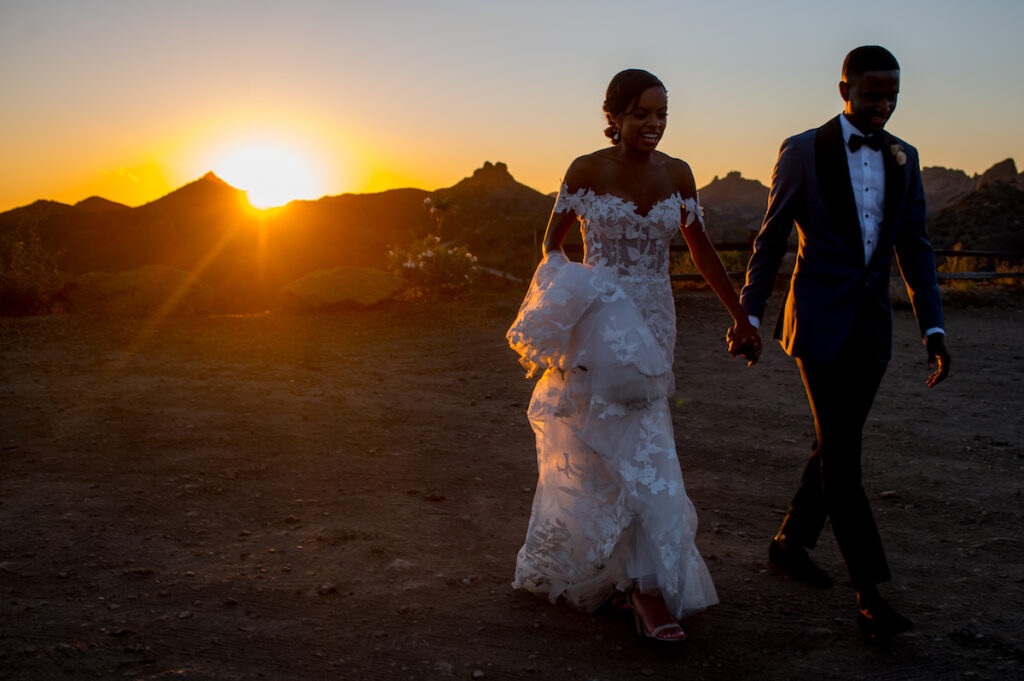 This hilltop vineyard wedding in Malibu is everything sweet with a sunset-inspired color story, an outdoor ceremony, and two glam dresses!