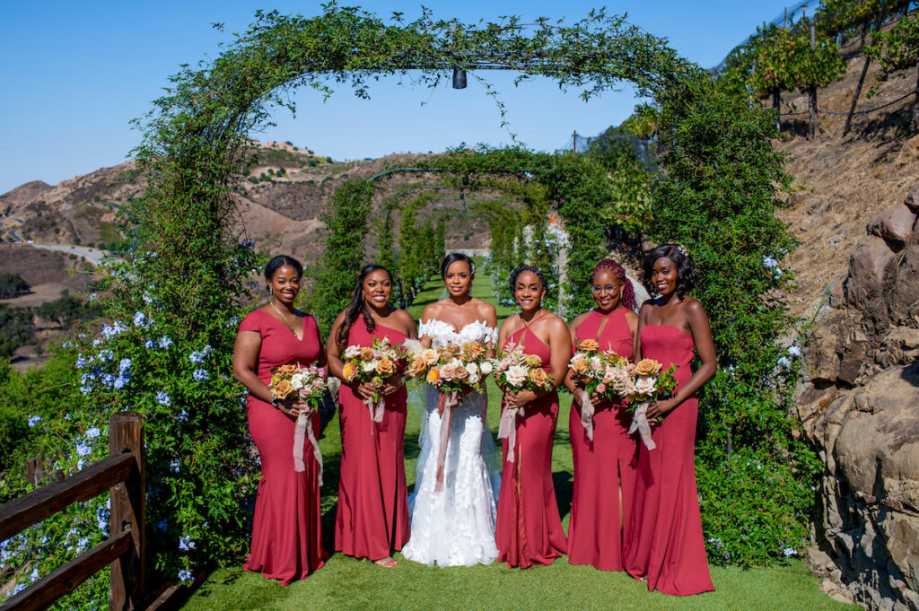 This hilltop vineyard wedding in Malibu is everything sweet with a sunset-inspired color story, an outdoor ceremony, and two glam dresses!