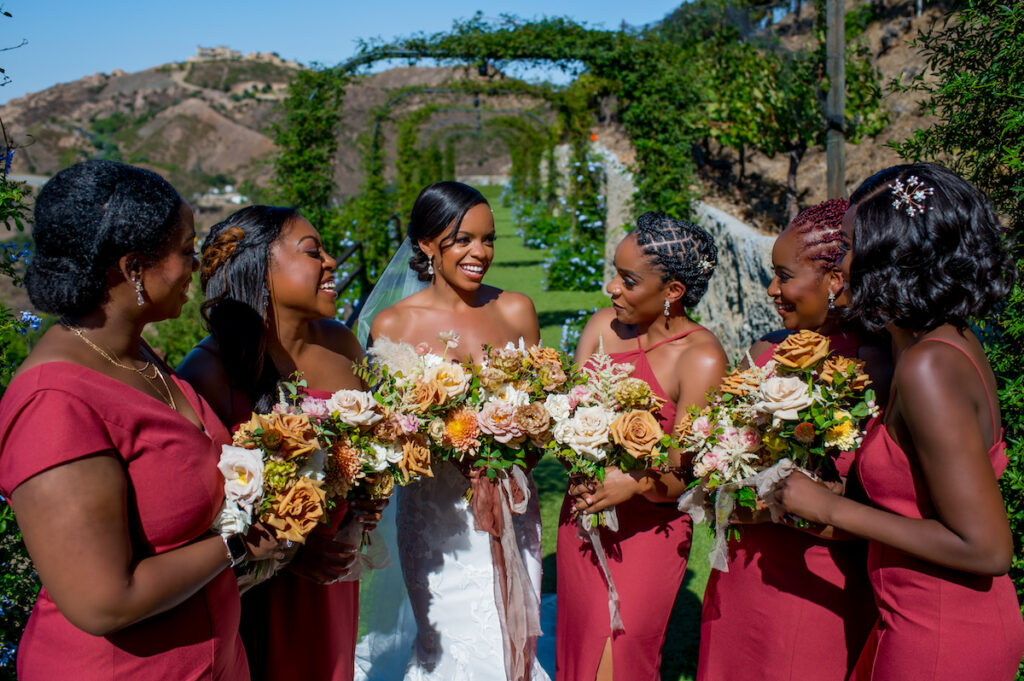 This hilltop vineyard wedding in Malibu is everything sweet with a sunset-inspired color story, an outdoor ceremony, and two glam dresses!