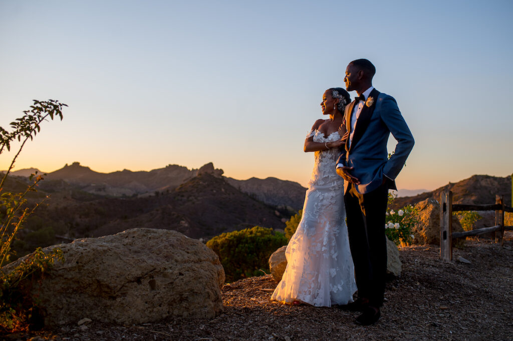 This hilltop vineyard wedding in Malibu is everything sweet with a sunset-inspired color story, an outdoor ceremony, and two glam dresses!
