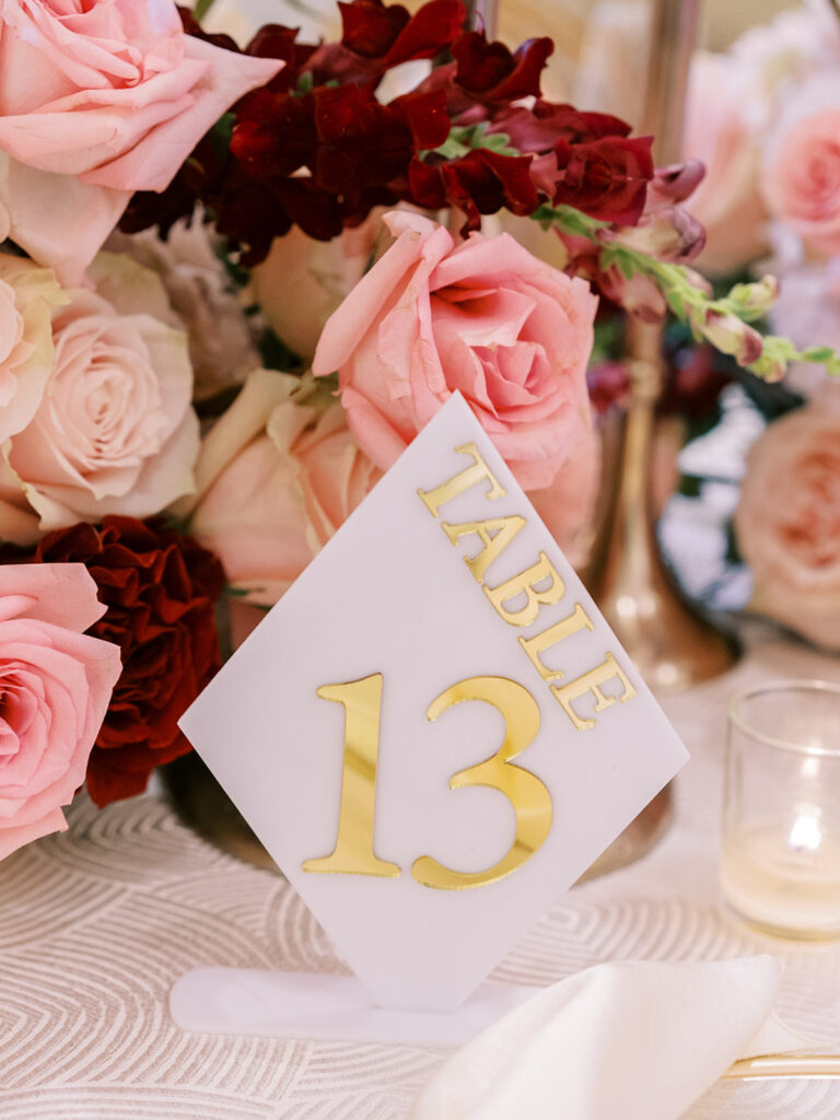 Featured in MunaLuchi Bride Magazine, Issue 28, red and pink florals bloom in this timeless wedding at the Atlanta History Center.