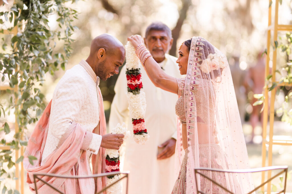 Indian nuptials features fuchsia florals, a sangeet pre-wedding party, and a stunning Hindu wedding ceremony at the New Orleans Museum of Art. 