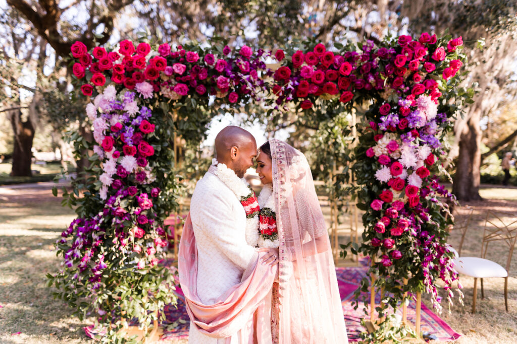 Indian nuptials features fuchsia florals, a sangeet pre-wedding party, and a stunning Hindu wedding ceremony at the New Orleans Museum of Art. 