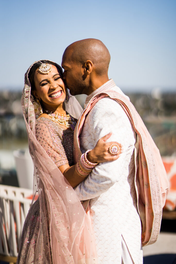 Indian nuptials features fuchsia florals, a sangeet pre-wedding party, and a stunning Hindu wedding ceremony at the New Orleans Museum of Art. 