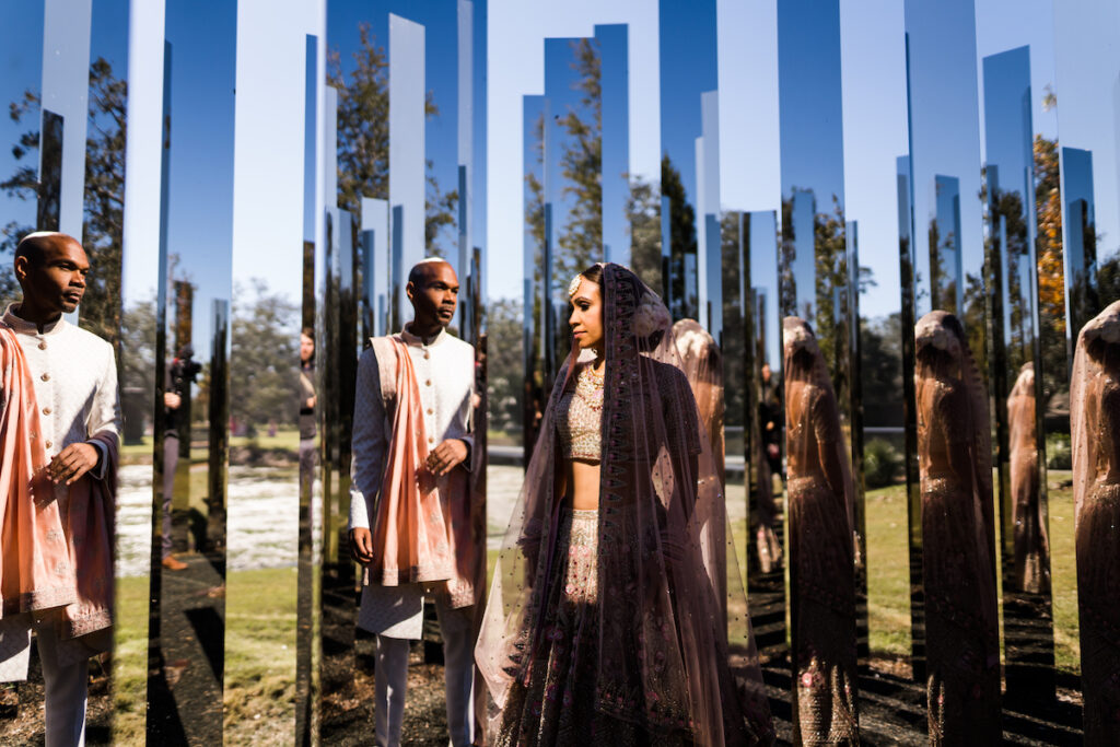 Indian nuptials features fuchsia florals, a sangeet pre-wedding party, and a stunning Hindu wedding ceremony at the New Orleans Museum of Art. 