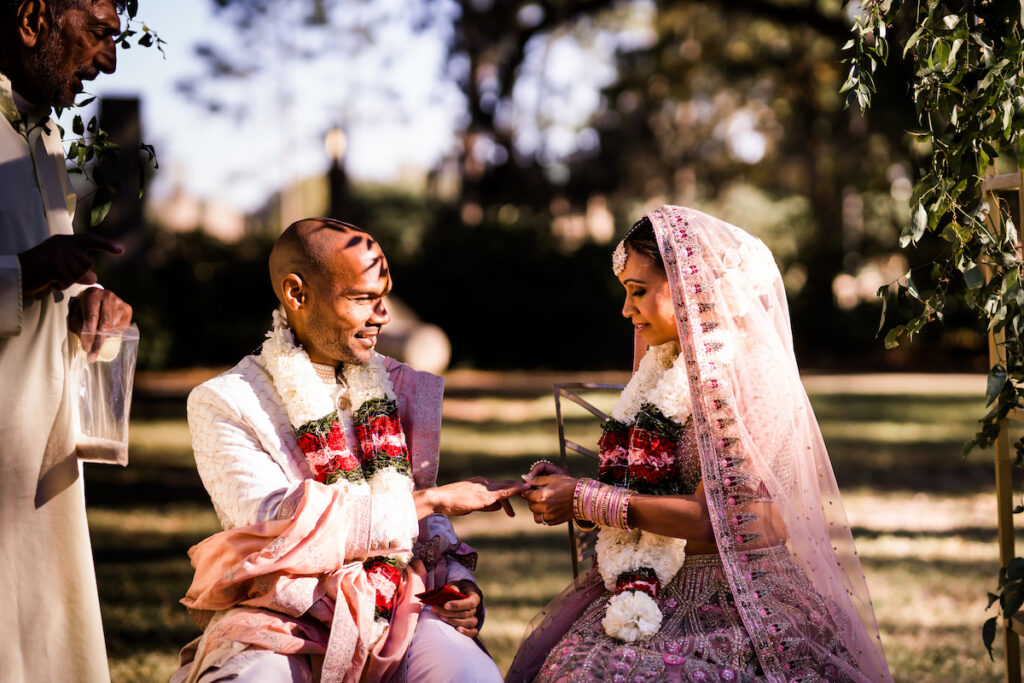 Indian nuptials features fuchsia florals, a sangeet pre-wedding party, and a stunning Hindu wedding ceremony at the New Orleans Museum of Art. 