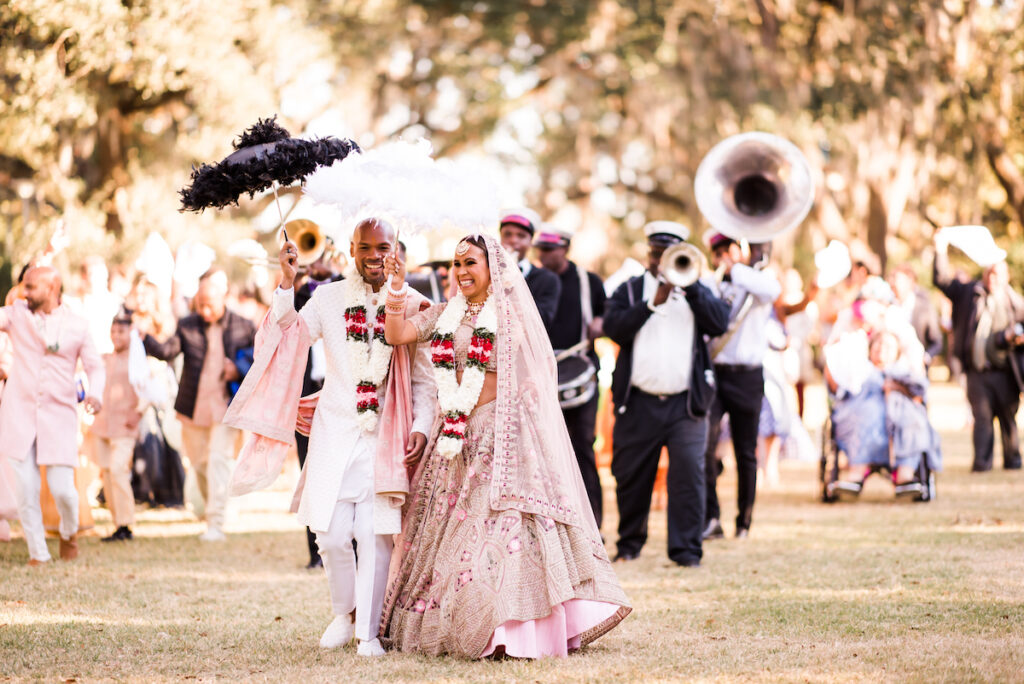 Indian nuptials features fuchsia florals, a sangeet pre-wedding party, and a stunning Hindu wedding ceremony at the New Orleans Museum of Art. 