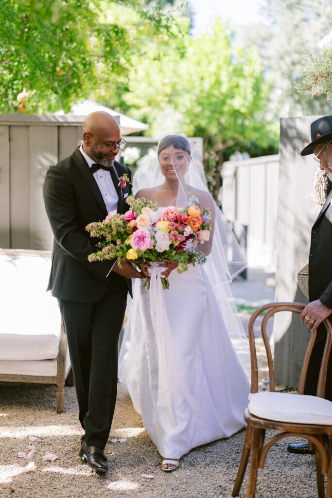 Bursting with colorful summer florals and sweet details, love blooms in this private estate wedding at the bride's grandmother's home in Walnut Creek, California.