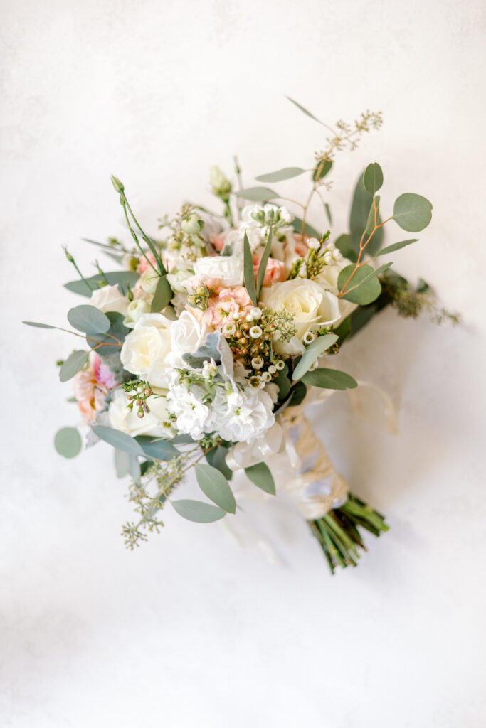 This waterfront wedding at the Tyee Yacht Club in Seattle, WA, features soft pink blooms, pops of red, and a bilingual English/Spanish ceremony.