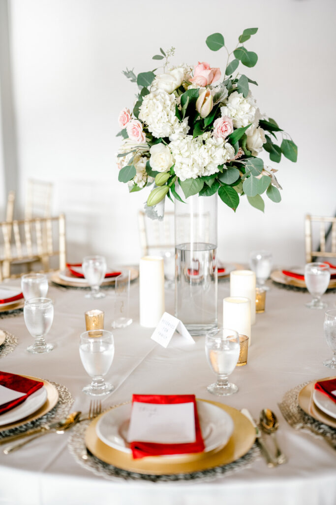This waterfront wedding at the Tyee Yacht Club in Seattle, WA, features soft pink blooms, pops of red, and a bilingual English/Spanish ceremony.