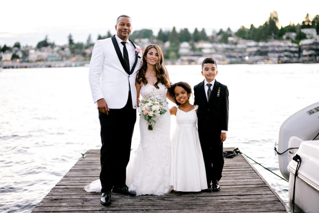 This waterfront wedding at the Tyee Yacht Club in Seattle, WA, features soft pink blooms, pops of red, and a bilingual English/Spanish ceremony.