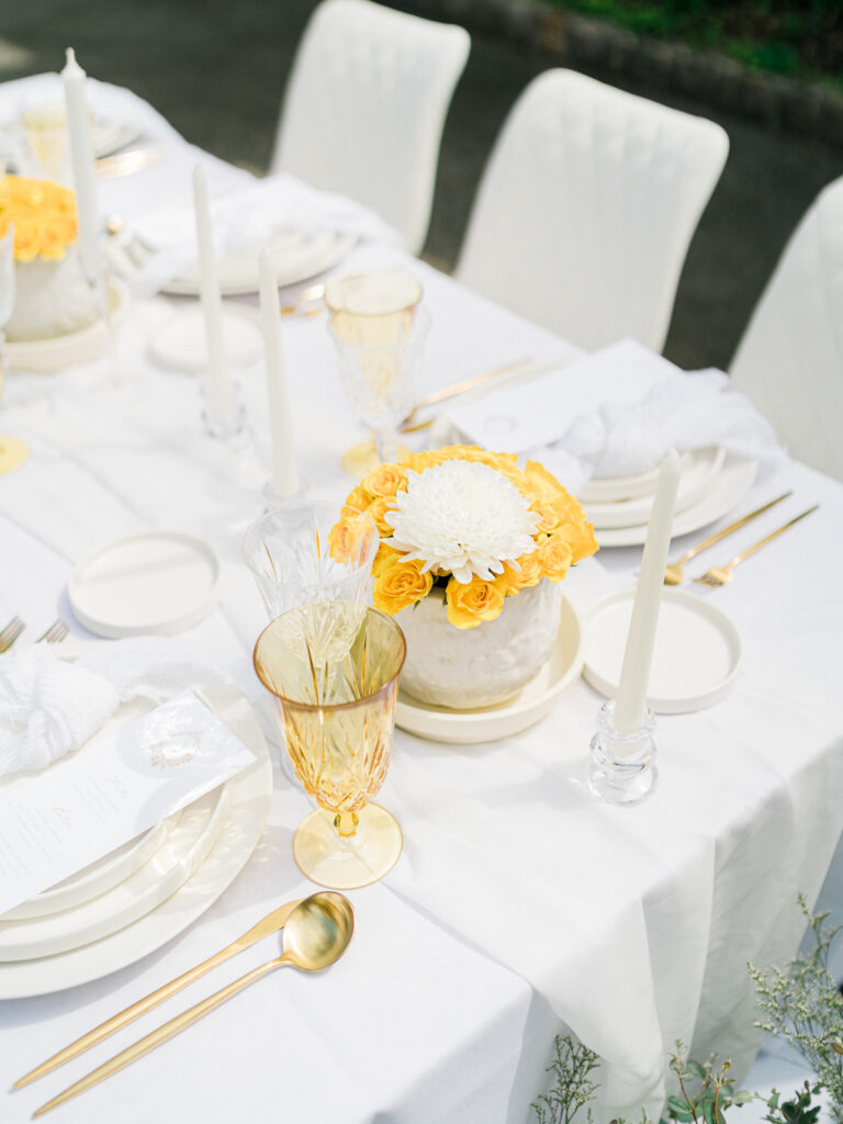 Inspired by the fresh feeling summer brings and the color yellow, this modern summer-styled shoot at the Swan House Atlanta History Center features a contemporary tablescape and decor with romantic touches and three fashion-forward bridal looks!