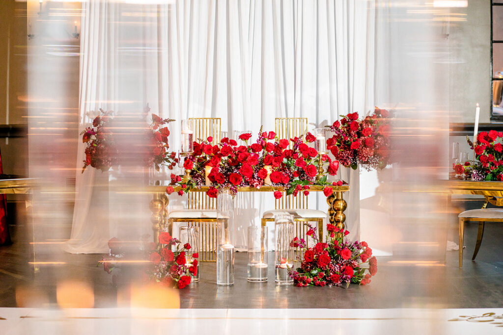 Jeremiah and Candace's luxe ballroom wedding in South Carolina featured oh-so-pretty red florals with an elegantly chic style.