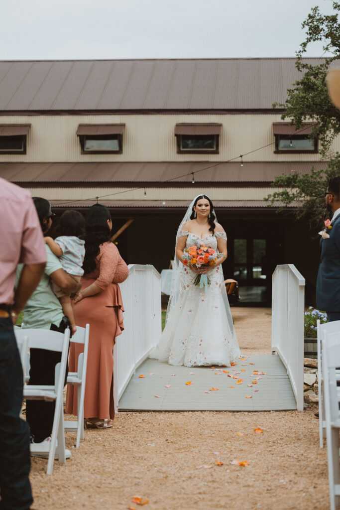 This charming rustic outdoor wedding was filled with vibrant summer florals and an unforgettable Morilee gown.