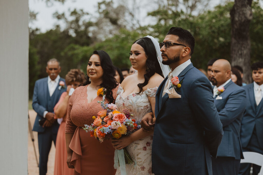 This charming rustic outdoor wedding was filled with vibrant summer florals and an unforgettable Morilee gown.