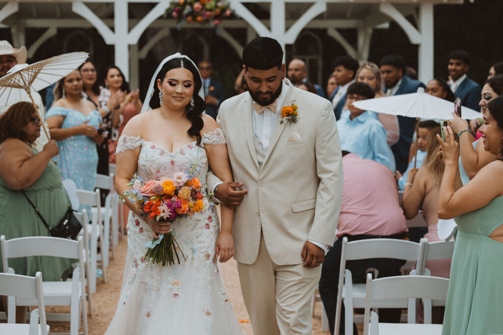 This charming rustic outdoor wedding was filled with vibrant summer florals and an unforgettable Morilee gown.