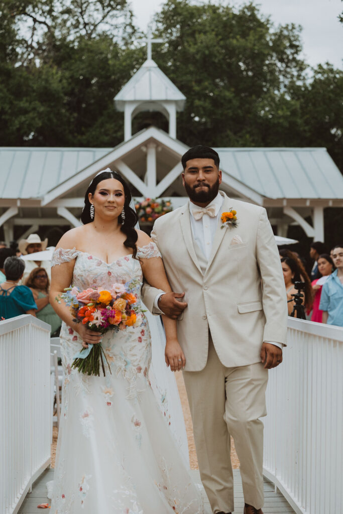 This charming rustic outdoor wedding was filled with vibrant summer florals and an unforgettable Morilee gown.