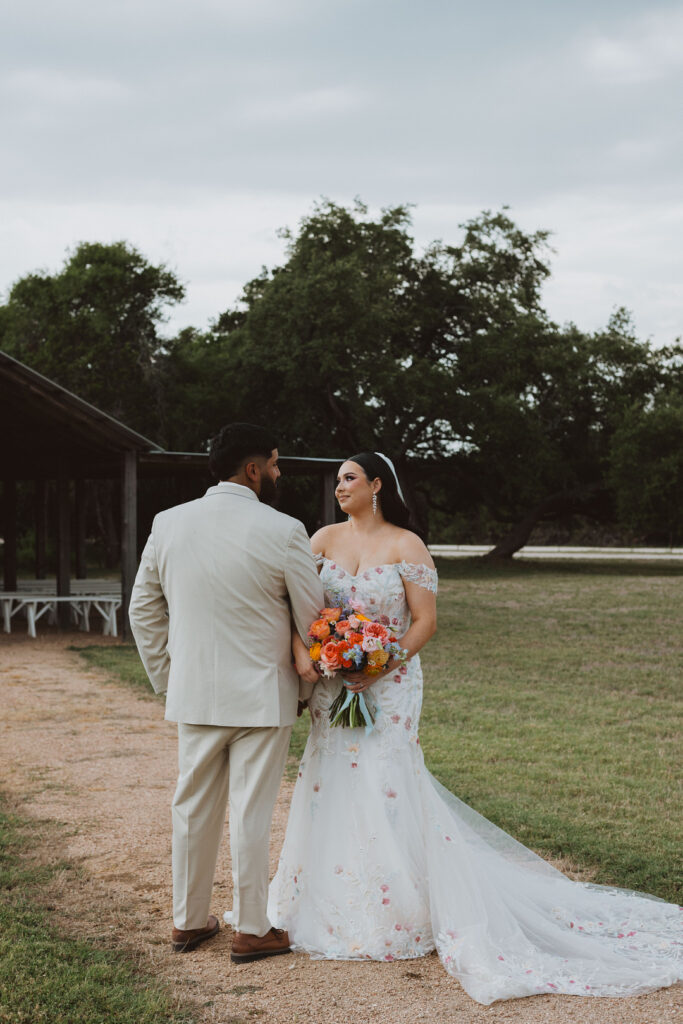 This charming rustic outdoor wedding was filled with vibrant summer florals and an unforgettable Morilee gown.