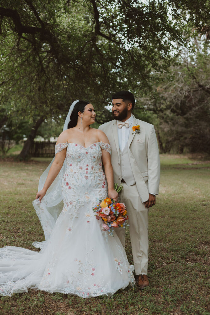 This charming rustic outdoor wedding was filled with vibrant summer florals and an unforgettable Morilee gown.