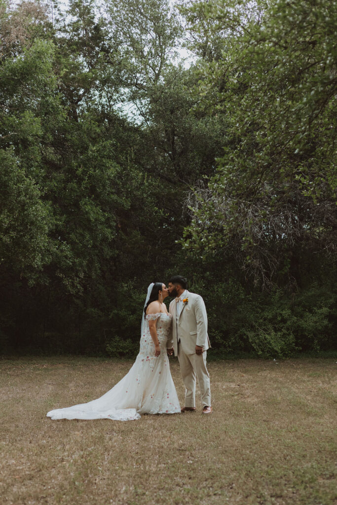 This charming rustic outdoor wedding was filled with vibrant summer florals and an unforgettable Morilee gown.