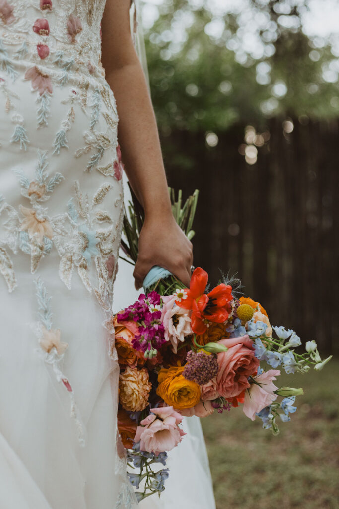 This charming rustic outdoor wedding was filled with vibrant summer florals and an unforgettable Morilee gown.